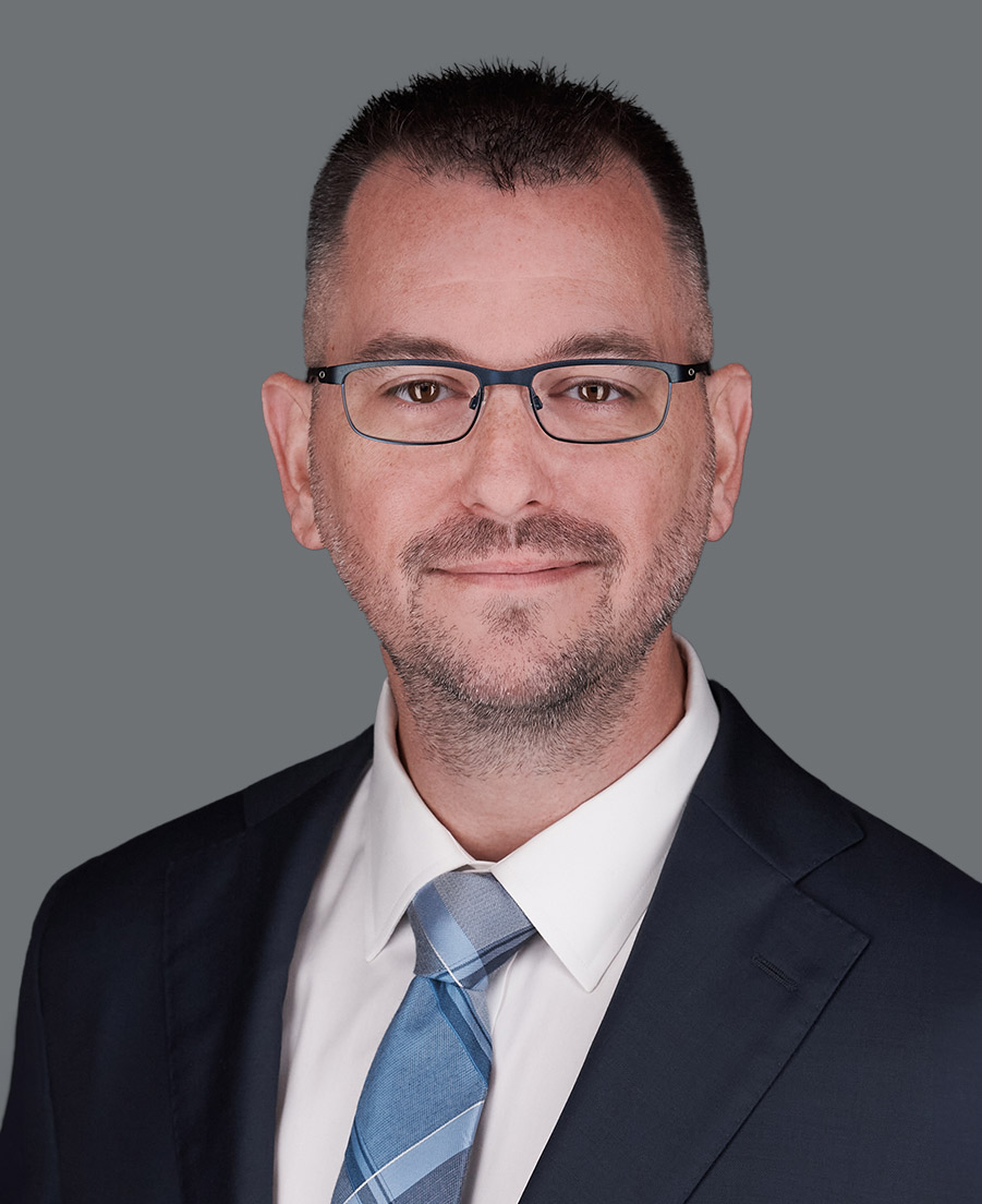 Man in glasses and suit and tie.