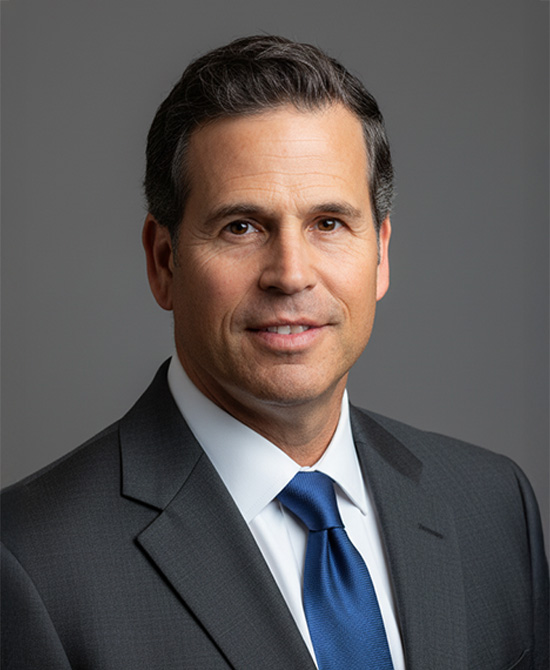 Man in a grey suit and blue tie