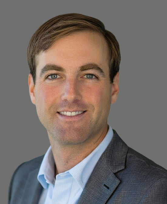 Man in a grey suit and blue shirt
